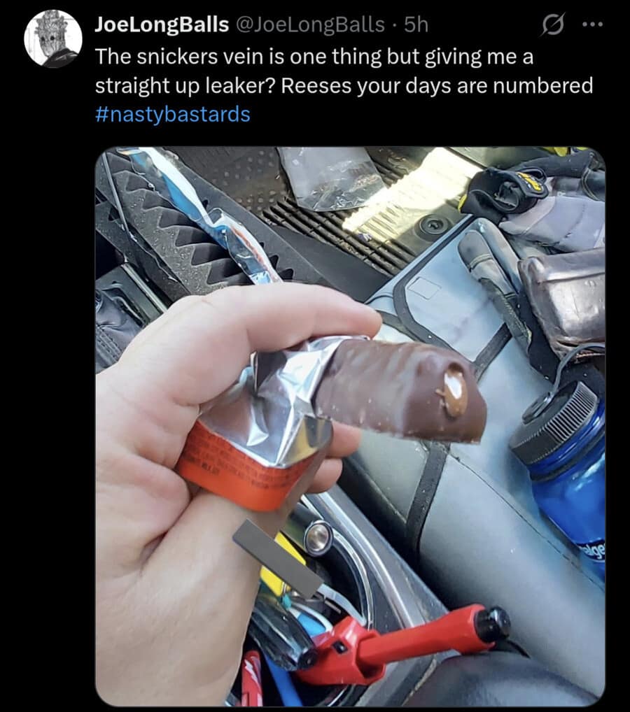 A food commentary post operating as a classic meme, showing a driver holding an unwrapped Reese's chocolate bar that is oozing peanut butter out of the side, angrily captioned: "The snickers vein is one thing but giving me a straight up leaker? Reeses your days are numbered."