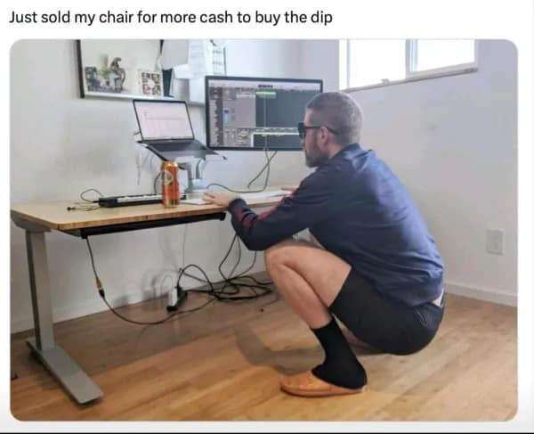A hilarious day-trading parody acting as a classic meme displays a man in dark sunglasses crouching in a deep Slav squat at his electronic standing desk with his office chair missing, under the text, "Just sold my chair for more cash to buy the dip."