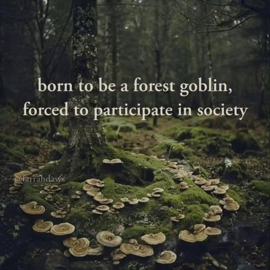 Mossy forest tree base surrounded by a wild mushroom fairy ring under text reading, "born to be a forest goblin, forced to participate in society".