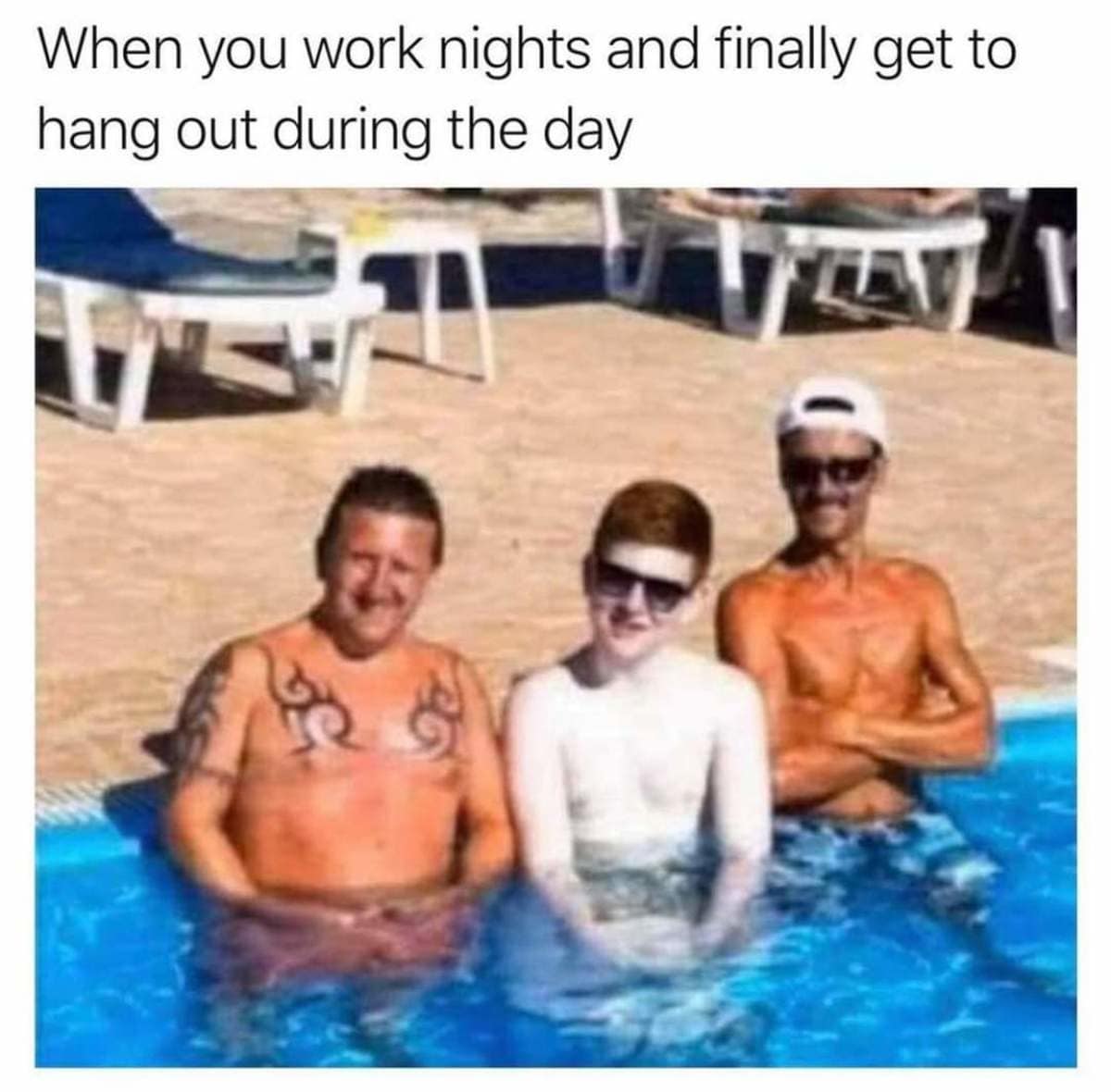 A hilarious lifestyle contrast classic meme captures three friends sitting together in an outdoor swimming pool, highlighting a stark-white, translucent redheaded man sitting directly between two heavily bronzed, deeply tanned companions under the caption: "When you work nights and finally get to hang out during the day".