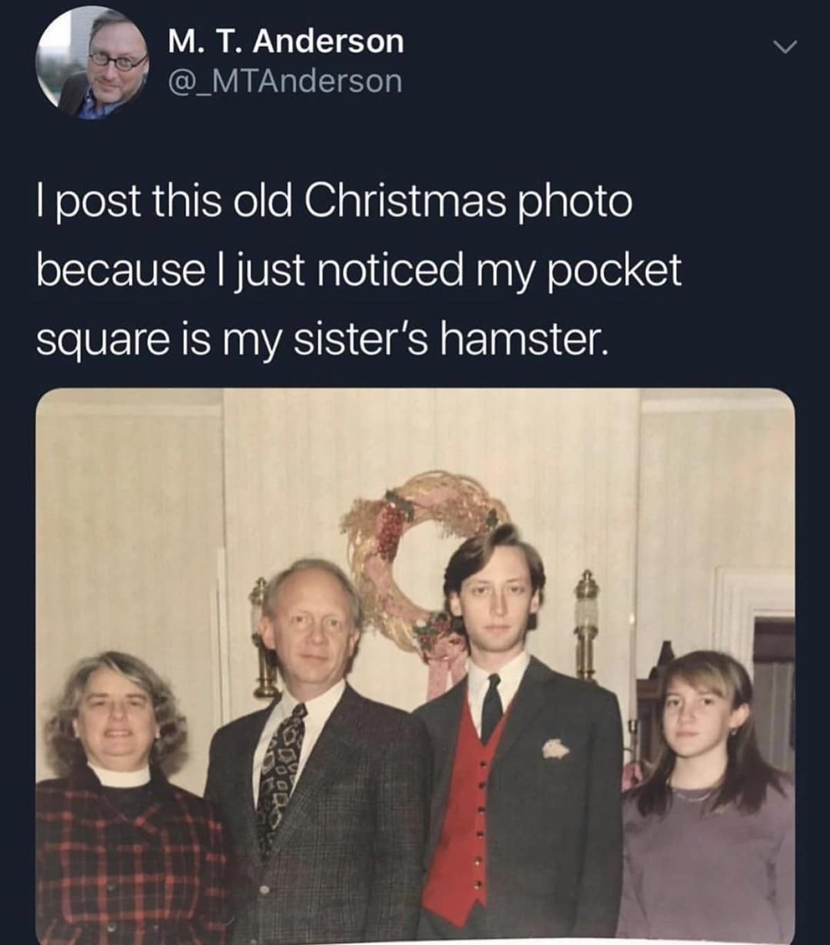 A legendary family portrait screenshot belonging to the pantheon of classic memes, showing a 1990s Christmas photo where the son's formal suit jacket pocket square is revealed to be his sister's live pet hamster peeking out.