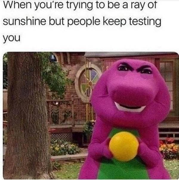 A hilarious childhood-satire classic meme showcases Barney the Dinosaur holding a yellow ball, edited to feature aggressively intense, furrowed human eyes and eyebrows under the text, "When you're trying to be a ray of sunshine but people keep testing you."