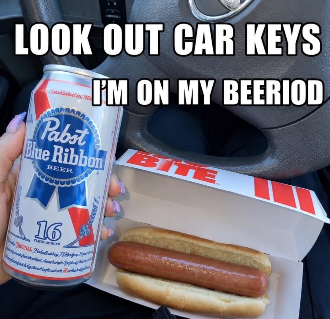 First-person view of a driver holding a Pabst Blue Ribbon beer next to a fast-food hot dog box with the chaotic text "LOOK OUT CAR KEYS I'M ON MY BEERIOD" in a wild classic meme.