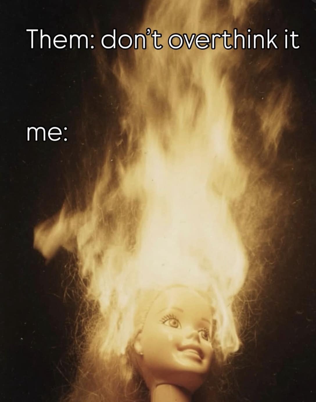 A striking mental-overwhelm visual acting as a classic meme showcases a Barbie doll's head completely engulfed in massive, glowing flames to perfectly illustrate the absolute chaos of overthinking a simple situation.
