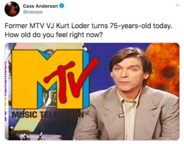A retro, low-resolution television news broadcast screenshot by Cass Anderson featuring host Kurt Loder on MTV News next to the massive iconic blue, yellow, and red MTV logo in a nostalgic classic meme.