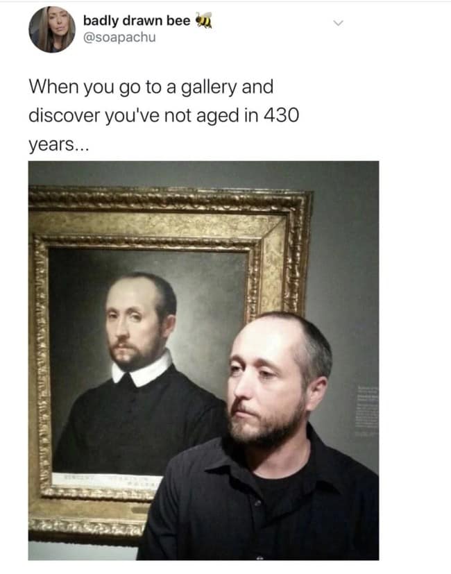 Museum photograph of a man posing next to an old master portrait of his historical doppelgänger.
