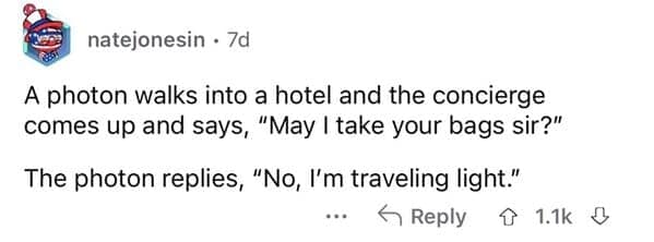 A screenshot of a Reddit comment by user natejonesin detailing a science-themed physics pun as a dumb joke about a photon walking into a hotel and refusing to have its bags taken because it's "traveling light."