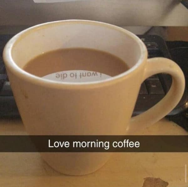 dark-humor Snapchat style dumb meme featuring a morning coffee mug where the white light reflection perfectly mirrors a hidden sticker or tag inside reading "i want to die," juxtaposed with the cheerful banner text, "Love morning coffee."