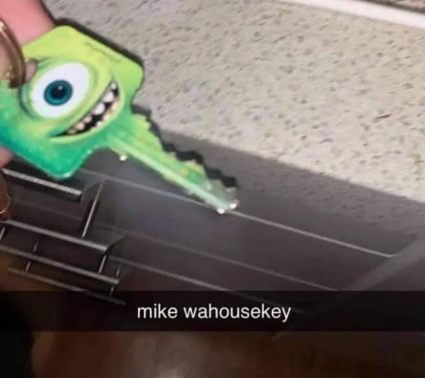 A goofy product-pun Snapchat screenshot operating as a dumb meme shows a hand holding a green house key custom-printed with Mike Wazowski's one-eyed face from Monsters Inc., captioned "mike wahousekey."