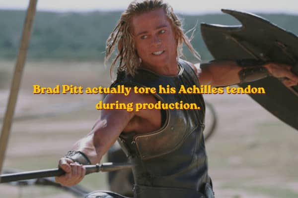 Brad Pitt wielding a sword on the battlefield, ironic text notes his real injury.