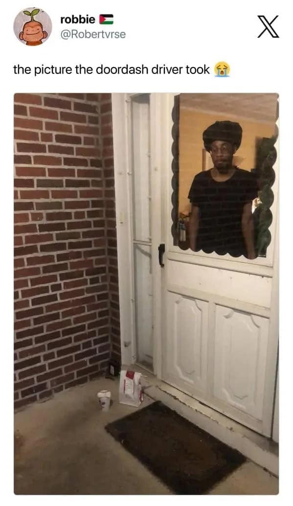 Food delivery meme showing a social media post about “the picture the DoorDash driver took,” with a delivery confirmation photo where the customer is visibly standing behind the door window staring out, making the drop-off proof look like found footage from a haunted porch.