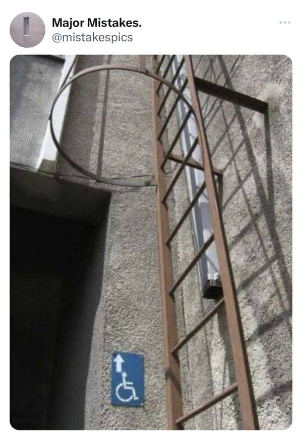 Terrible disability compliance design showing a wheelchair symbol arrow pointing straight up a vertical ladder.