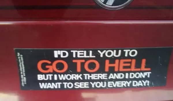 Red car bumper sticker stating that they work in hell and don't want passengers.