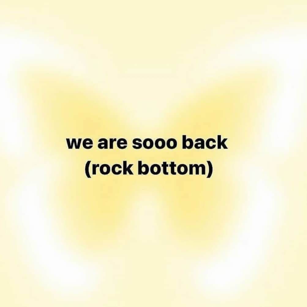 Text meme reading we are so back rock bottom over a blurry yellow background.