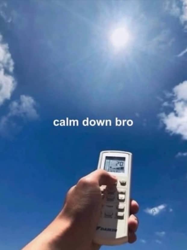First person view of a hand pointing an air conditioner remote directly at the sun.