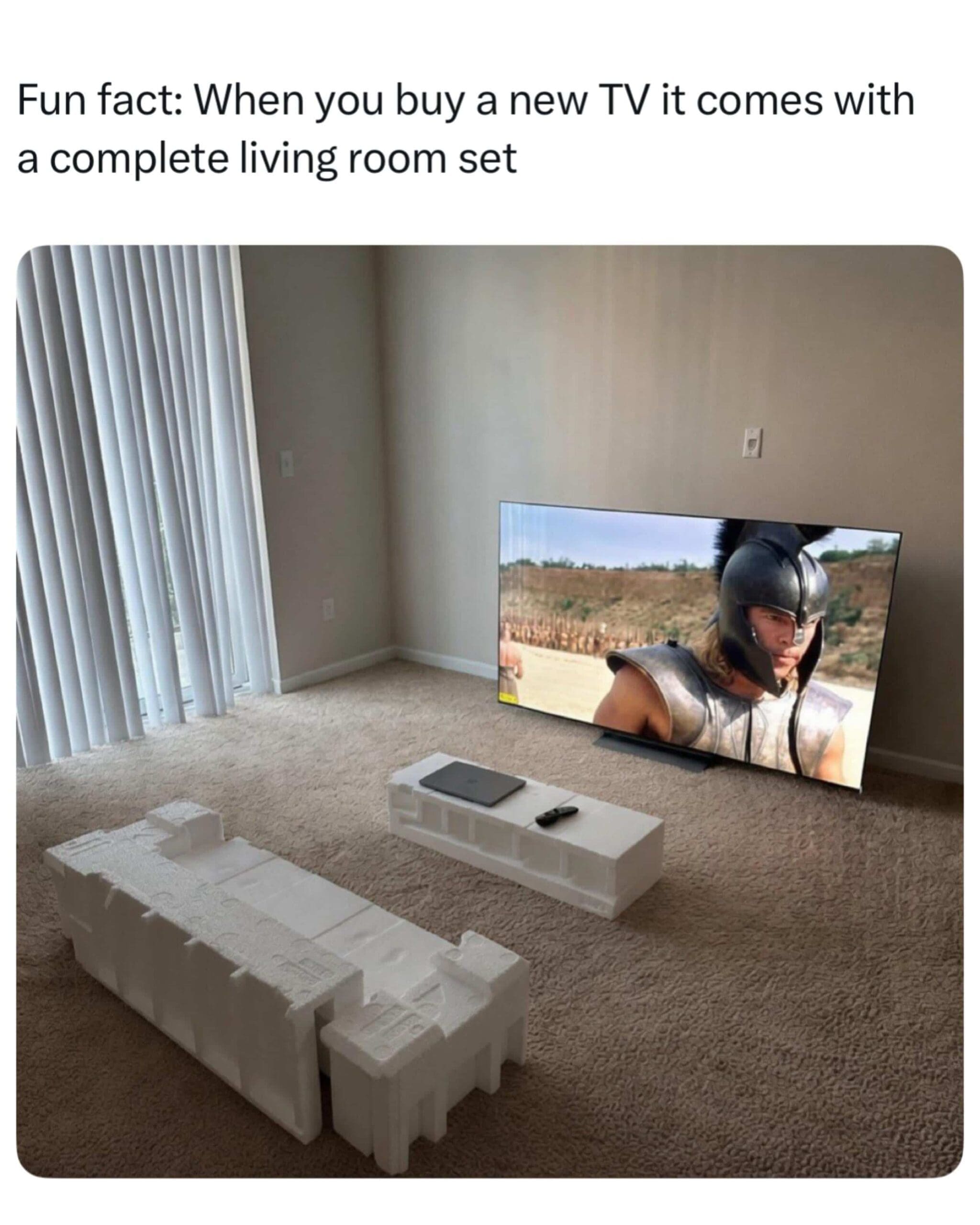 Living room utilizing styrofoam packaging blocks as a makeshift couch and coffee table.