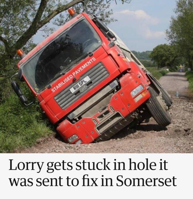 A classic piece of civil infrastructure irony captured as a funny news headline displays a large red utility truck emblazoned with "STABILISED PAVEMENTS" completely stuck nose-first in a muddy ditch, under the text: "Lorry gets stuck in hole it was sent to fix in Somerset."