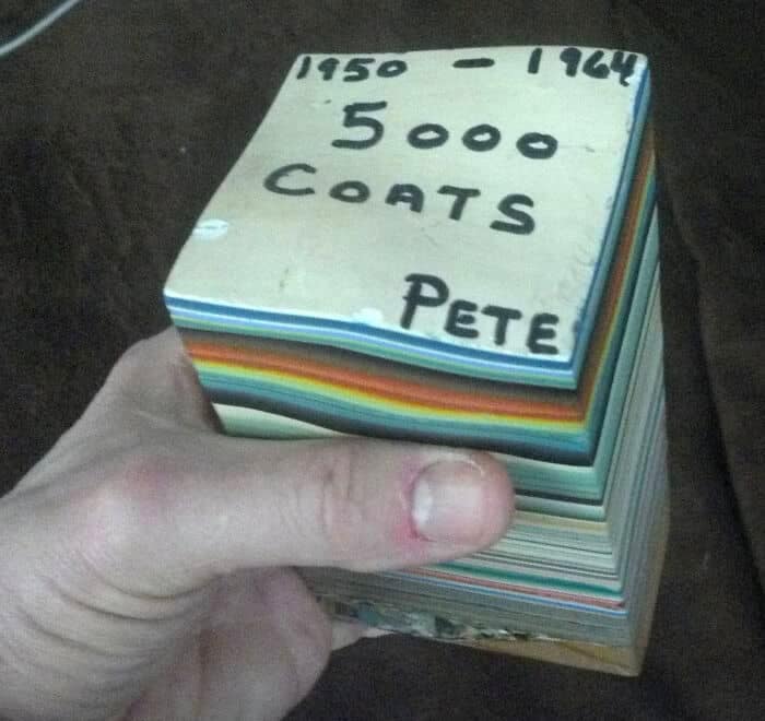 A fascinating funny thrift store find showcasing a solid, thick cube made entirely of thousands of colorful layers of stacked paint, bearing the handwritten text "1950 - 1964 5000 COATS PETE."