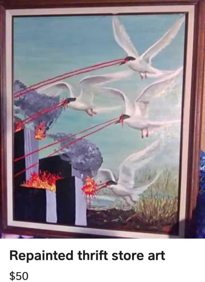 A drastically altered landscape painting shared as a funny thrift store find, where a standard coastal painting of flying seagulls has been heavily repainted so that the birds are shooting bright red laser beams out of their eyes to set black city buildings on fire.