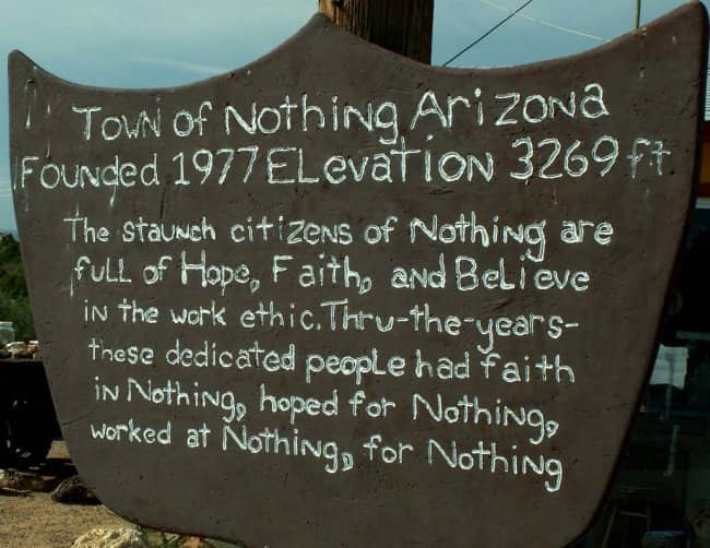 Hand-written wooden sign describing the humorous, literal philosophy of Nothing, Arizona.