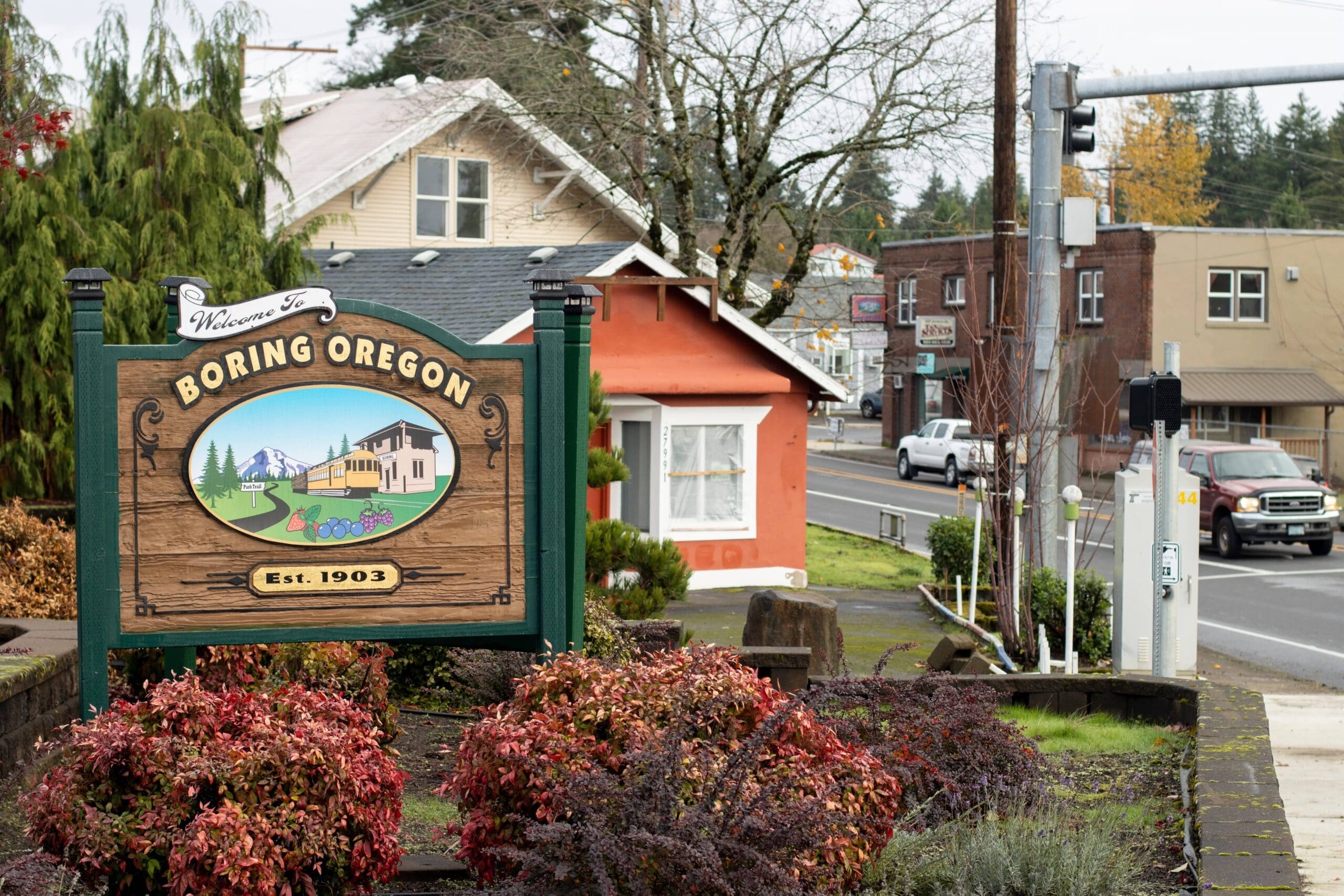 Beautifully landscaped wooden welcome sign for the community of Boring, Oregon.