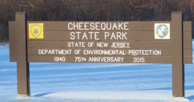 Large brown wooden welcome sign for Cheesequake State Park in New Jersey.