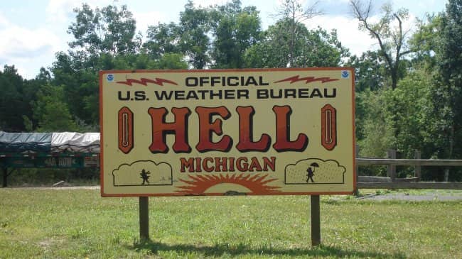 Large yellow official U.S. Weather Bureau station sign for Hell, Michigan.