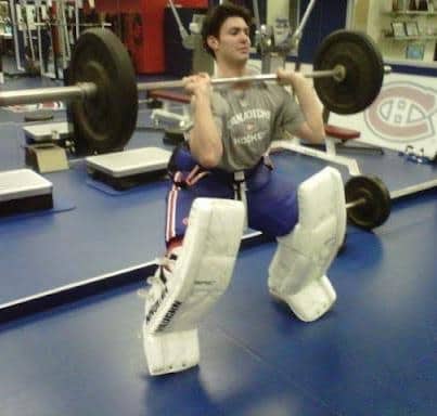 Humorous hockey meme showing a player doing front squats in the gym while wearing massive goalie pads.