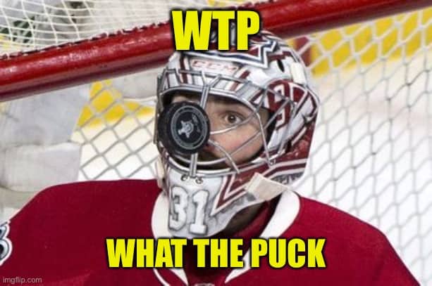 Funny hockey goalie meme showing a puck wedged directly into the metal cage of a face mask.