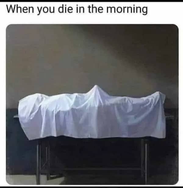 A body outline visible under a white sheet with a joke about morning.