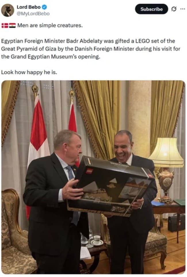 Wholesome news tweet of a politician looking ecstatic while receiving a LEGO pyramid.