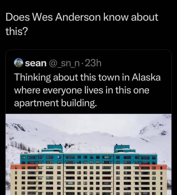 A symmetrical blue, beige, and orange apartment building in Alaska with a Wes Anderson tweet.