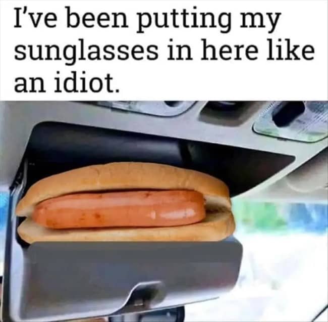 Absurd car meme with a hot dog stored in an overhead sunglasses compartment.