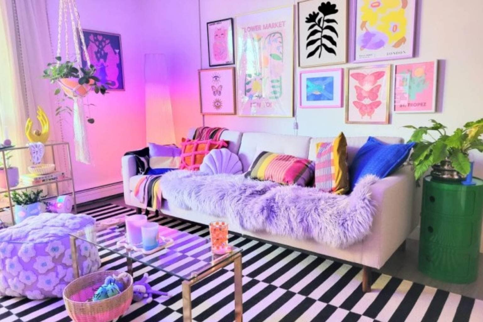 An inspiring design lookbook celebrating maximalist interior design through unapologetic color saturation and pattern play, capturing a monochrome living space completely enveloped in electric chartreuse green paint, a high-contrast bathroom containing a giant hot-pink hand-shaped accent chair, and a pet-friendly Victorian gallery wall where a majestic black cat rests on a miniature custom chaise lounge.