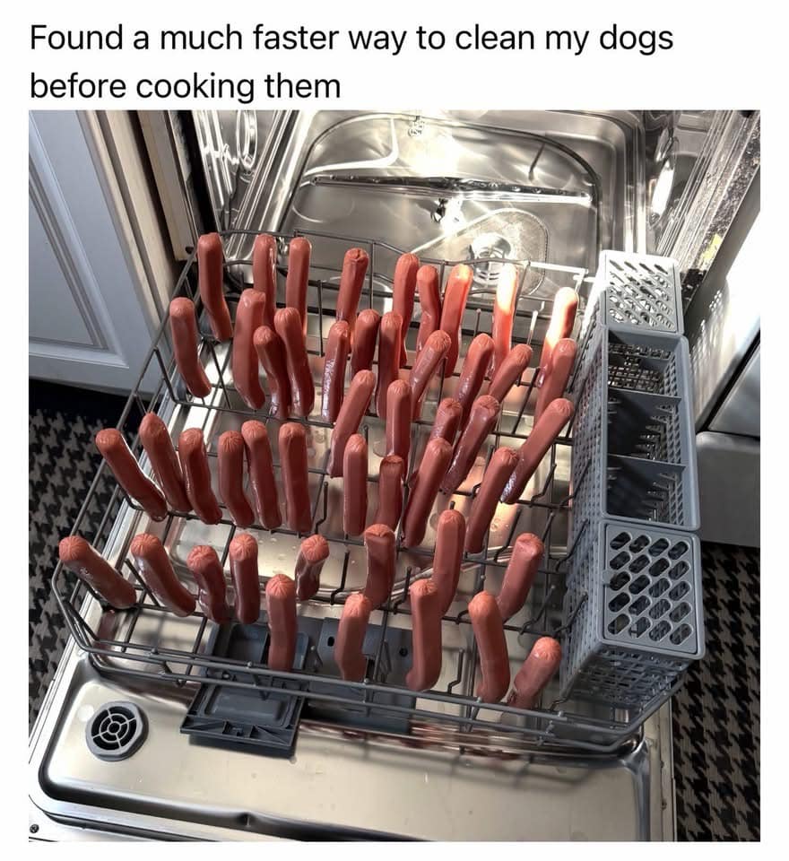 A chaotic culinary photograph from a meme dump showing a modern kitchen dishwasher with its bottom rack completely packed full of raw hot dogs stood vertically on the tines, topped with the caption: "Found a much faster way to clean my dogs before cooking them".