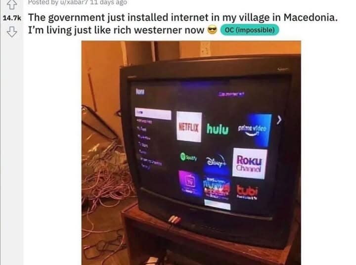 screenshot from a popular Reddit thread inside a meme dump featuring an old 90s CRT television set clumsily running a modern Roku smart TV streaming interface, accented by a giant, unorganized pile of pink internet cables tangled on the floor behind the stand.