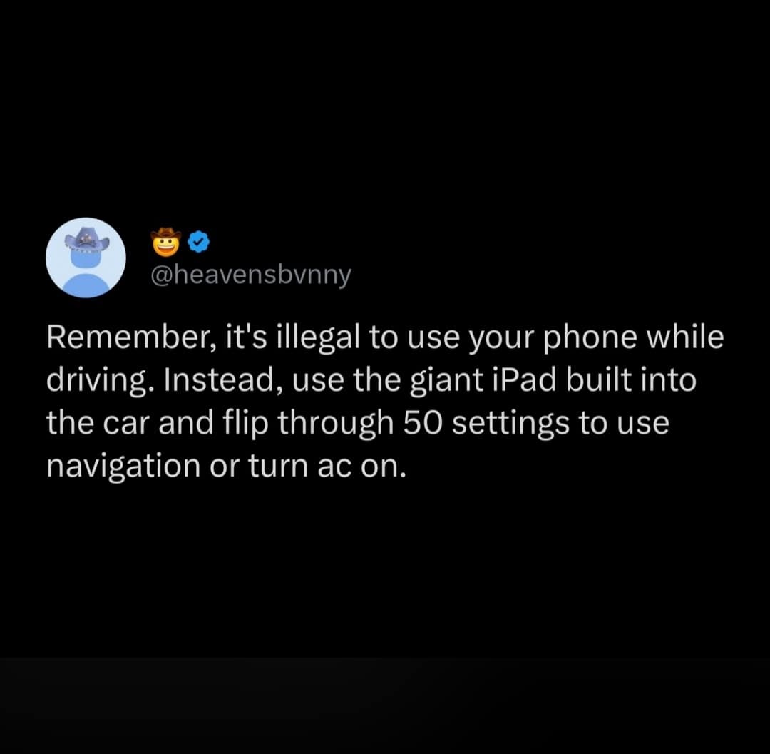 tweet from a viral meme dump criticizing modern automotive engineering, dryly pointing out the hypocrisy of laws banning driving while texting while car manufacturers install massive, menu-dense touchscreen tablets to simply adjust the air conditioning or view navigation.