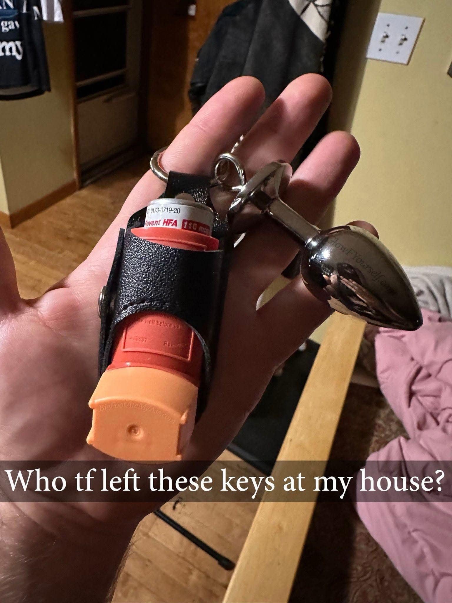 A wild lost-and-found object post circulating in this meme dump shows a close-up photo of a hand holding a house key ring equipped with an orange asthma rescue inhaler and a large, polished silver metal butt plug under the caption, "Who tf left these keys at my house?".