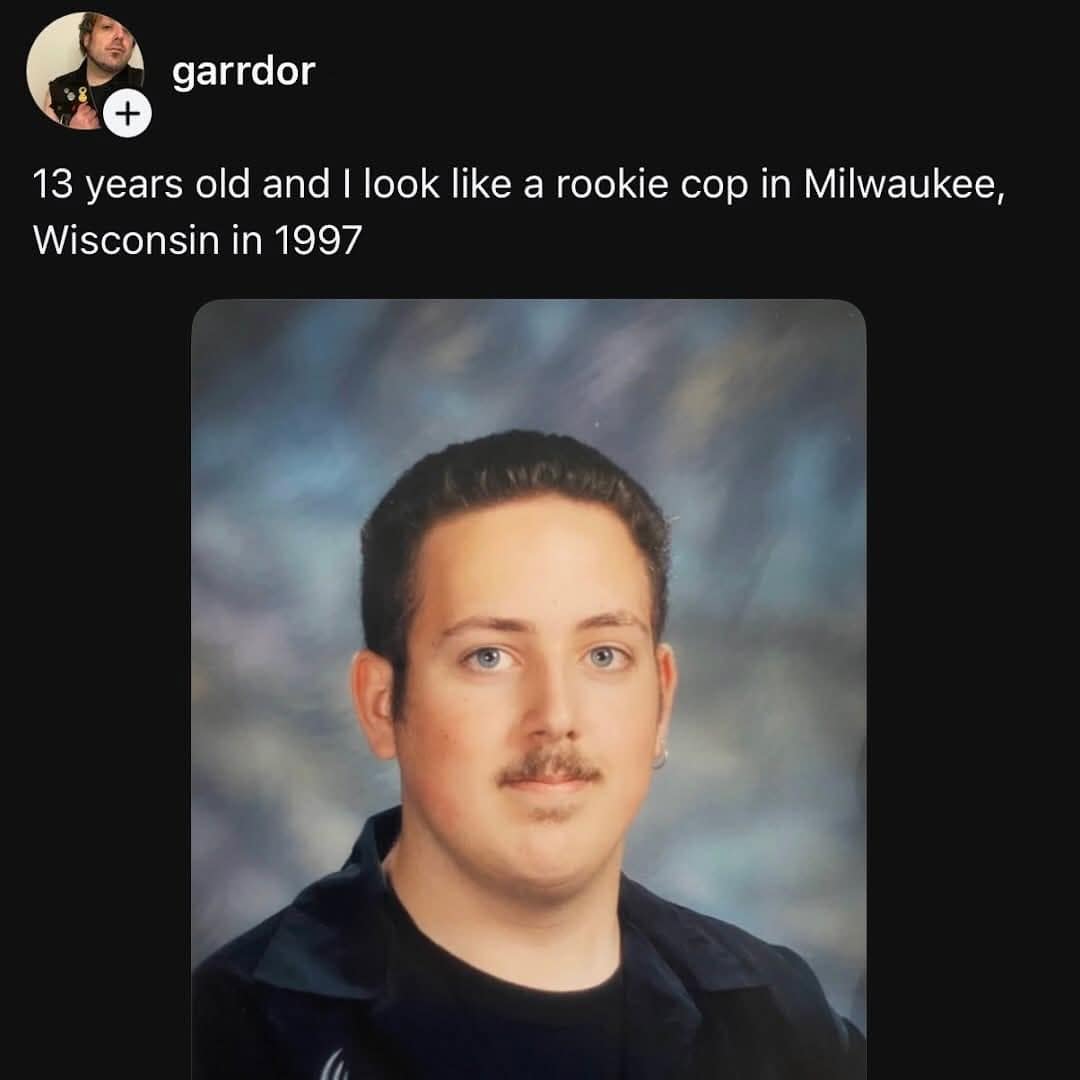 A 1990s school yearbook portrait of a middle school boy possessing a fully grown adult mustache, presented as a funny meme about looking like a 1997 Milwaukee rookie cop.