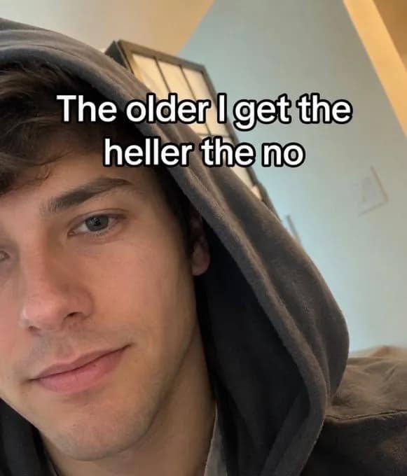 Man in a dark hoodie looking at the lens in a personal boundary text macro graphic from a meme dump.