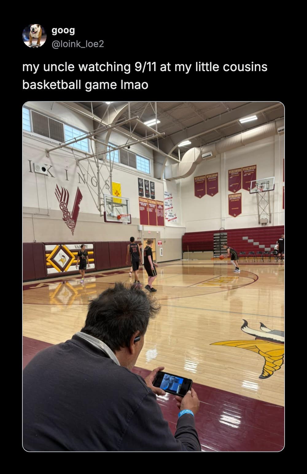 A meme dump screenshot of a Twitter post displaying an older man sitting on gym bleachers holding his smartphone horizontally to watch 9/11 documentary footage during a youth basketball game.