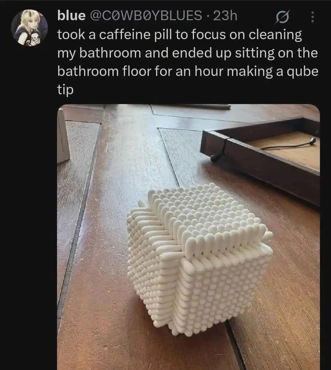 This hilarious meme displays a highly detailed geometric cube structure meticulously constructed out of white cotton swabs on a wooden table, born out of a severe, caffeine-fueled cleaning distraction.