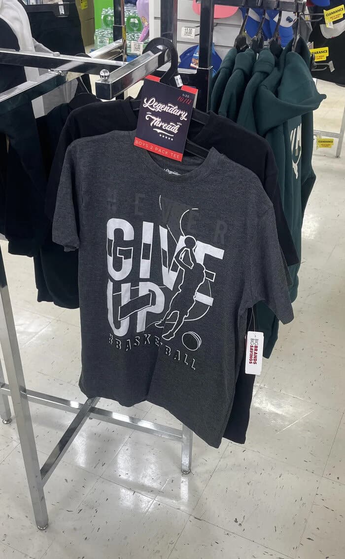 A motivational design fail captured in a meme dump shows a gray clothing rack t-shirt where the word "NEVER" is practically invisible, leaving the giant bold white text to mistakenly scream "GIVE UP" across a basketball graphic.