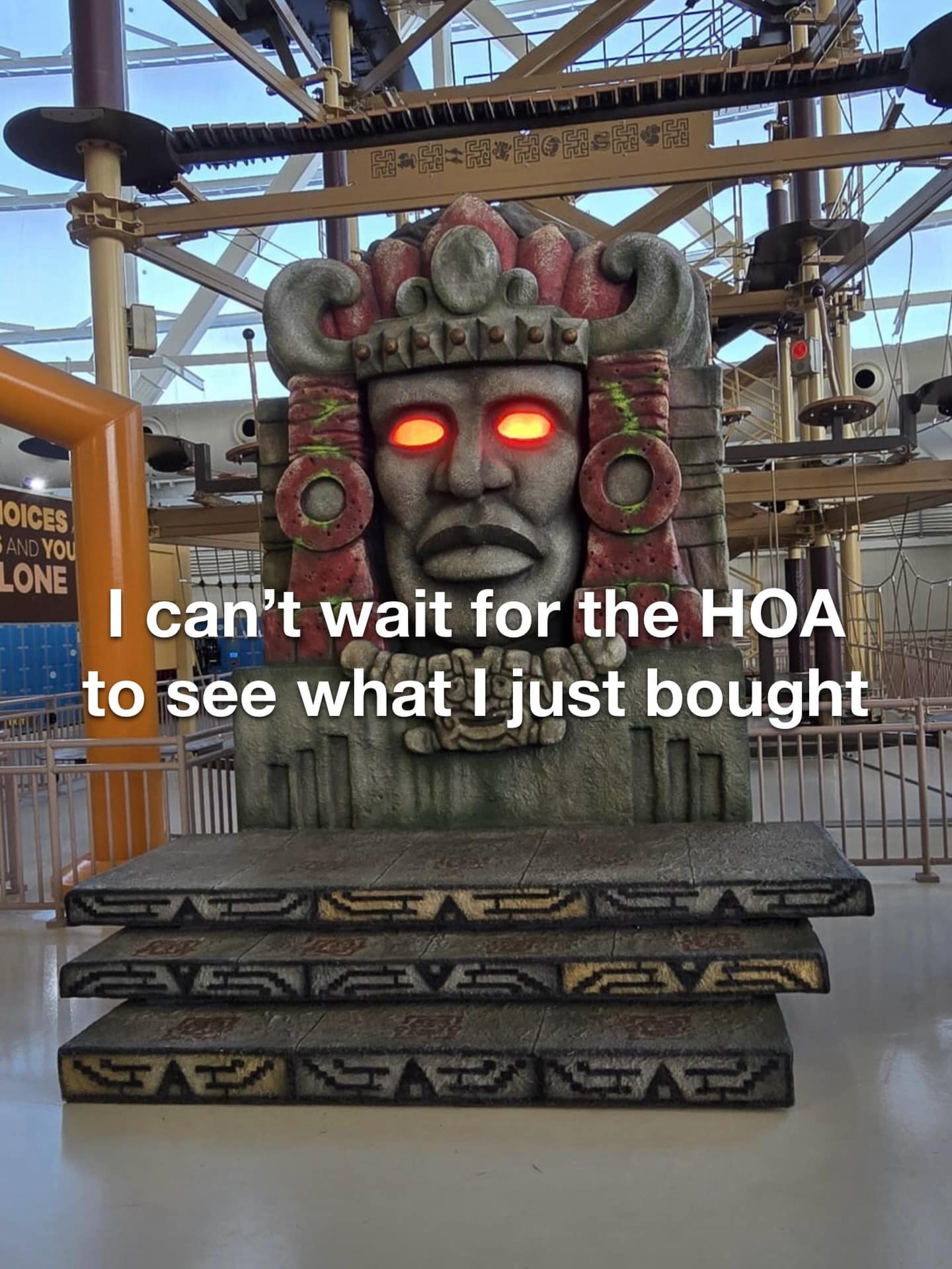 A hilarious lawn decoration photo featured in a meme dump showcasing a massive indoor replica of Olmec—the legendary talking stone head from the 90s game show Legends of the Hidden Temple—overlaid with the text: "I can't wait for the HOA to see what I just bought."