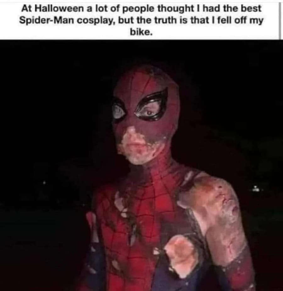 Painful accident memes capturing a dark photo of a person wearing a completely ruined, shredded, and dirt-stained Spider-Man costume, captioned with a text header explaining that everyone thought it was an elite cosplay but they actually just fell off their bicycle.