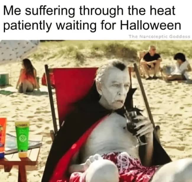 Vampire dressed in trunks sitting on a sunny beach waiting impatiently for Halloween season.