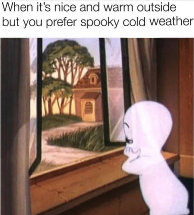 Casper the Friendly Ghost looking out a sunny window longing for cold spooky weather.