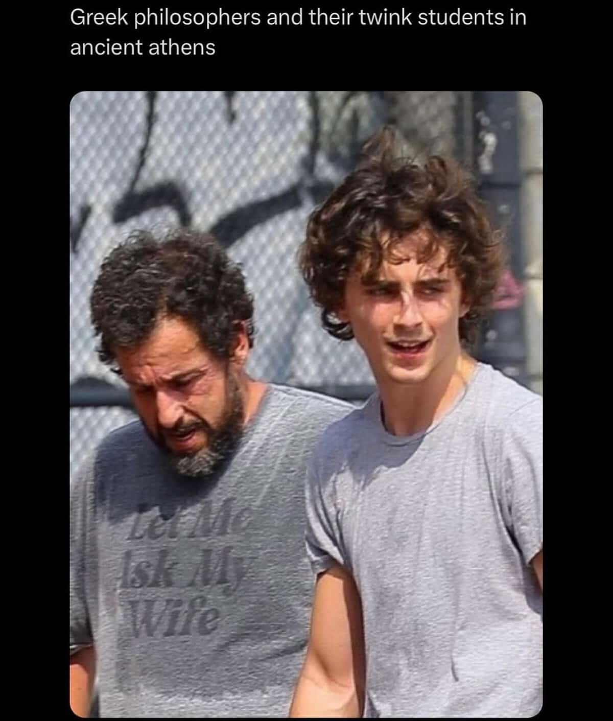 A candid celebrity street photo operating as a historical memes with twist endings joke, framing Adam Sandler and Timothée Chalamet as an ancient Greek philosopher and his student.