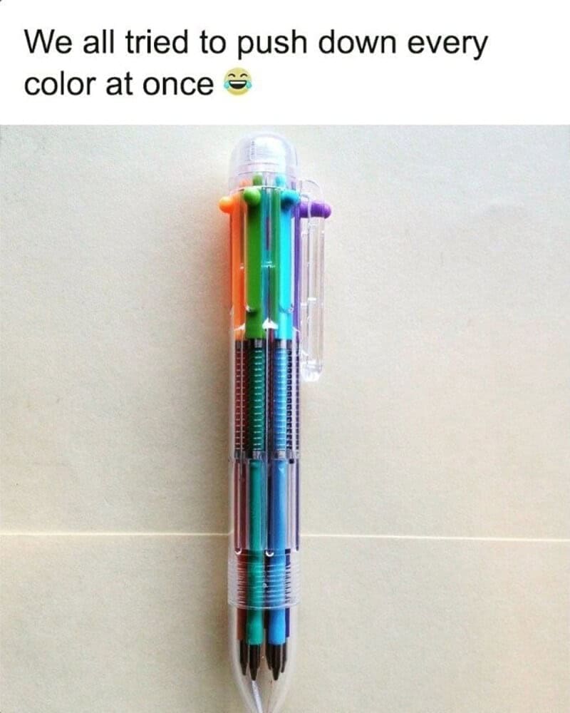 A universally relatable nostalgia meme showing a clear plastic multi-color push-down shuttle ballpoint pen with orange, green, blue, and purple buttons, captioned with the text, "We all tried to push down every color at once".