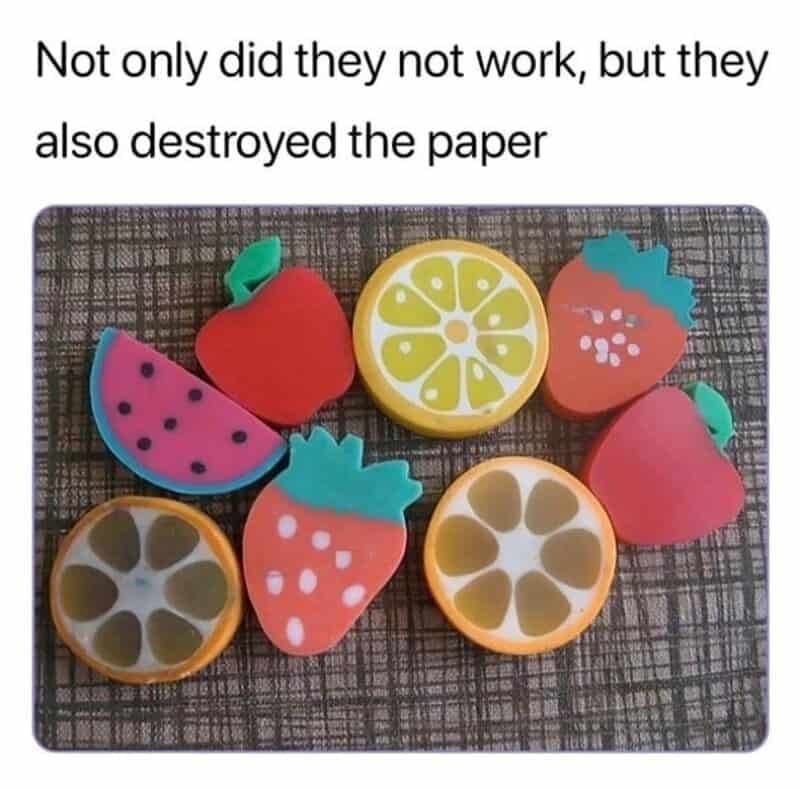A frustrating school-supply nostalgia meme featuring an assortment of colorful, fruit-shaped novelty rubber erasers resembling apples, strawberries, watermelons, and orange slices, paired with the caption: "Not only did they not work, but they also destroyed the paper".